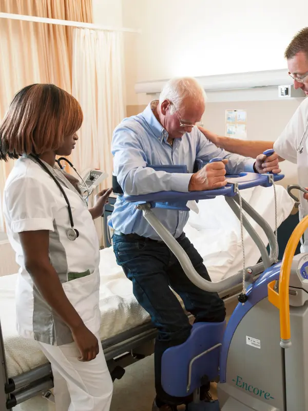 Healthcare professionals assisting an older patient with rehabilitation as part of personalized naturopathic care.